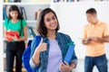 Spanish female student showing thumb up with group of students Royalty Free Stock Photo