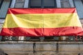 Spanish flag hanging on the balcony of a house in Spain Royalty Free Stock Photo