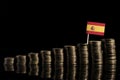 Spanish flag with lot of coins on black Royalty Free Stock Photo