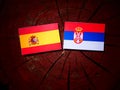 Spanish flag with Serbian flag on a tree stump Royalty Free Stock Photo