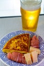 Spanish food and drink, glass of fresh beer and portion of potato omelette tortilla de patatas with onion served with cheese and