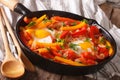 Spanish Food: pepper with fried egg in a pan close-up Royalty Free Stock Photo