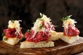 Spanish food tapas. Toasted bread with meat Royalty Free Stock Photo