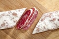 Spanish fuet salami cuts on wooden board Royalty Free Stock Photo