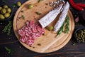 Spanish fuet salami sausageon wooden cutting board at domestic kitchen Royalty Free Stock Photo