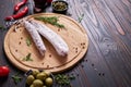 Spanish fuet salami sausageon wooden cutting board at domestic kitchen Royalty Free Stock Photo