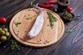 Spanish fuet salami sausageon wooden cutting board at domestic kitchen Royalty Free Stock Photo