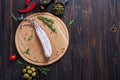 Spanish fuet salami sausageon wooden cutting board at domestic kitchen Royalty Free Stock Photo