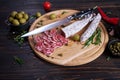 Spanish fuet salami sausageon wooden cutting board at domestic kitchen Royalty Free Stock Photo