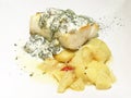 Codfish with sauce and potatoes. Close view Royalty Free Stock Photo
