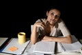 Spanish girl studying tired and bored at home late night absent minded looking thoughtful and happy Royalty Free Stock Photo