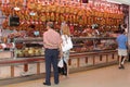 Couple buys delicious Spanish ham Iberico at the market, Valencia, Spain