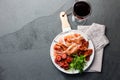 Spanish ham serrano and salami on white marbled plate an red wine. Top view. Royalty Free Stock Photo