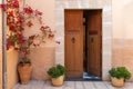 Spanish house with door and flowers on street Royalty Free Stock Photo