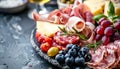 Spanish jamon, pork sausage, fuet, cheese, and berries charcuterie board for a delightful spread