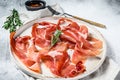 Spanish jamon Serrano, ham. Antipasto plate. Gray background, top view Royalty Free Stock Photo