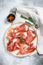 Spanish jamon Serrano, ham. Antipasto plate. Gray background, top view Royalty Free Stock Photo