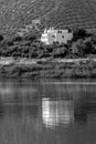 Spanish lake with reflection of a white house and olive groves