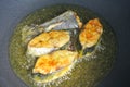 Spanish mackerels fish cut into thick slices and fried using hot cooking oil.