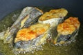 Spanish mackerels fish cut into thick slices and fried using hot cooking oil.