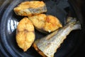 Spanish mackerels fish cut into thick slices and fried using hot cooking oil.