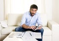 Spanish mexican business man worried paying bills on couch Royalty Free Stock Photo