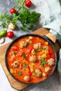 Hot stew tomato soup with meatballs and vegetables. Top view on a flat lay Royalty Free Stock Photo