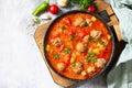 Hot stew tomato soup with meatballs and vegetables. Top view on a flat lay. Free space for Royalty Free Stock Photo