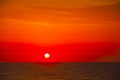 Spanish morning sun on red sky with yellow clouds by the Mediterranean sea Royalty Free Stock Photo