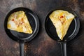 Spanish omelette, fresh red chilli, brown and white crabmeat, lemon, Cheddar cheese, eggs fried, on frying iron pan, on old dark Royalty Free Stock Photo