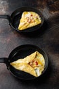 Spanish omelette, fresh red chilli, brown and white crabmeat, lemon, Cheddar cheese, eggs fried, on frying iron pan, on old dark Royalty Free Stock Photo