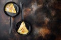 Spanish omelette, fresh red chilli, brown and white crabmeat, lemon, Cheddar cheese, eggs fried, on frying iron pan, on old dark Royalty Free Stock Photo