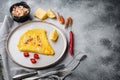 Spanish omelette, fresh red chilli, brown and white crabmeat, lemon, Cheddar cheese, eggs fried, on plate, on gray background ,