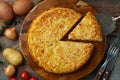 Spanish omelette with potatoes and onion, typical Spanish cuisine. Tortilla espanola. Rustic dark background. Top view Royalty Free Stock Photo