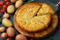 Spanish omelette with potatoes and onion, typical Spanish cuisine. Tortilla espanola. Rustic dark background. Top view Royalty Free Stock Photo