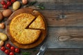 Spanish omelette with potatoes and onion, typical Spanish cuisine. Tortilla espanola. Rustic dark background. Top view Royalty Free Stock Photo