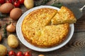 Spanish omelette with potatoes and onion, typical Spanish cuisine. Tortilla espanola. Rustic dark background. Top view Royalty Free Stock Photo