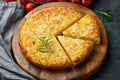 Spanish omelette with potatoes and onion, typical Spanish cuisine. Tortilla espanola. Rustic dark background. Top view Royalty Free Stock Photo