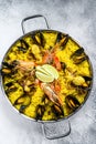 The Spanish paella with seafood prawns, shrimps, mussels in a paellera. White background. Top view. Copy space Royalty Free Stock Photo