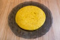 Spanish potato omelette on a gray glass plate ready to serve in