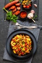 spanish potato salad with chorizo in black bowl Royalty Free Stock Photo