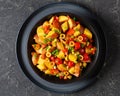 spanish potato salad with chorizo in black bowl Royalty Free Stock Photo