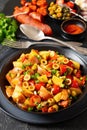 spanish potato salad with chorizo in black bowl Royalty Free Stock Photo