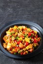 spanish potato salad with chorizo in black bowl Royalty Free Stock Photo