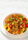 spanish potato salad with chorizo in white bowl Royalty Free Stock Photo