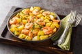 Spanish Potatoes roasted with Garlic Shrimp close-up in a plate. Horizontal