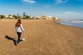 Spanish pre-adolescent girl strolling carefree with her soccer ball on Burriana beach with the Mediterranean Sea in the Royalty Free Stock Photo