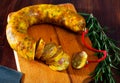 Spanish sausage butifarra on a wooden table, closeup