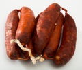 Spanish sausage chorizo on white background, closeup