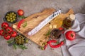 Spanish sausage fuet salami and vegetables on a domestic kitchen